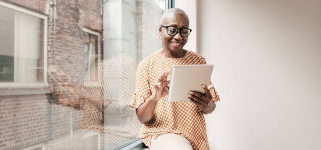 Woman scrolling on tablet